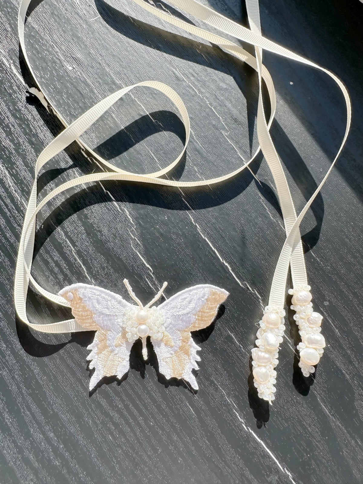 Handmade Choker featuring delicate hand-stitched embroidery of a Ivory color butterfly, adorned with freshwater pearls and glass seed beads