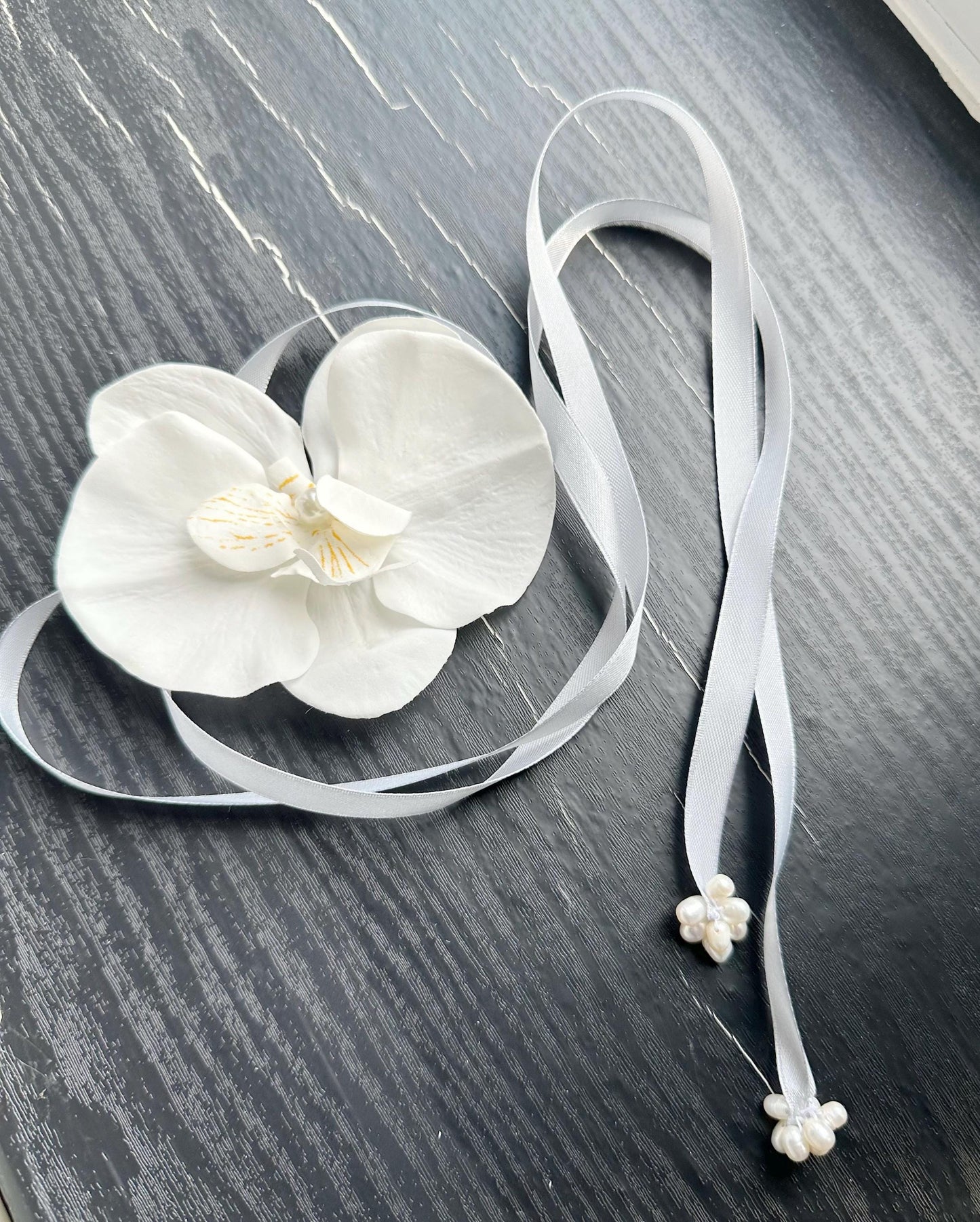 Handmade white orchid choker necklace with gray color ribbon end with freshwater pearls