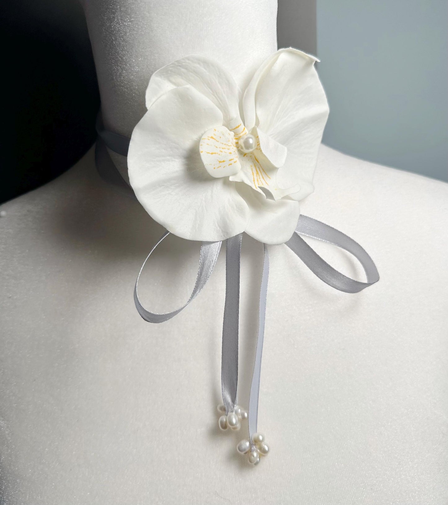 Handmade white orchid choker necklace with gray color ribbon end with freshwater pearls