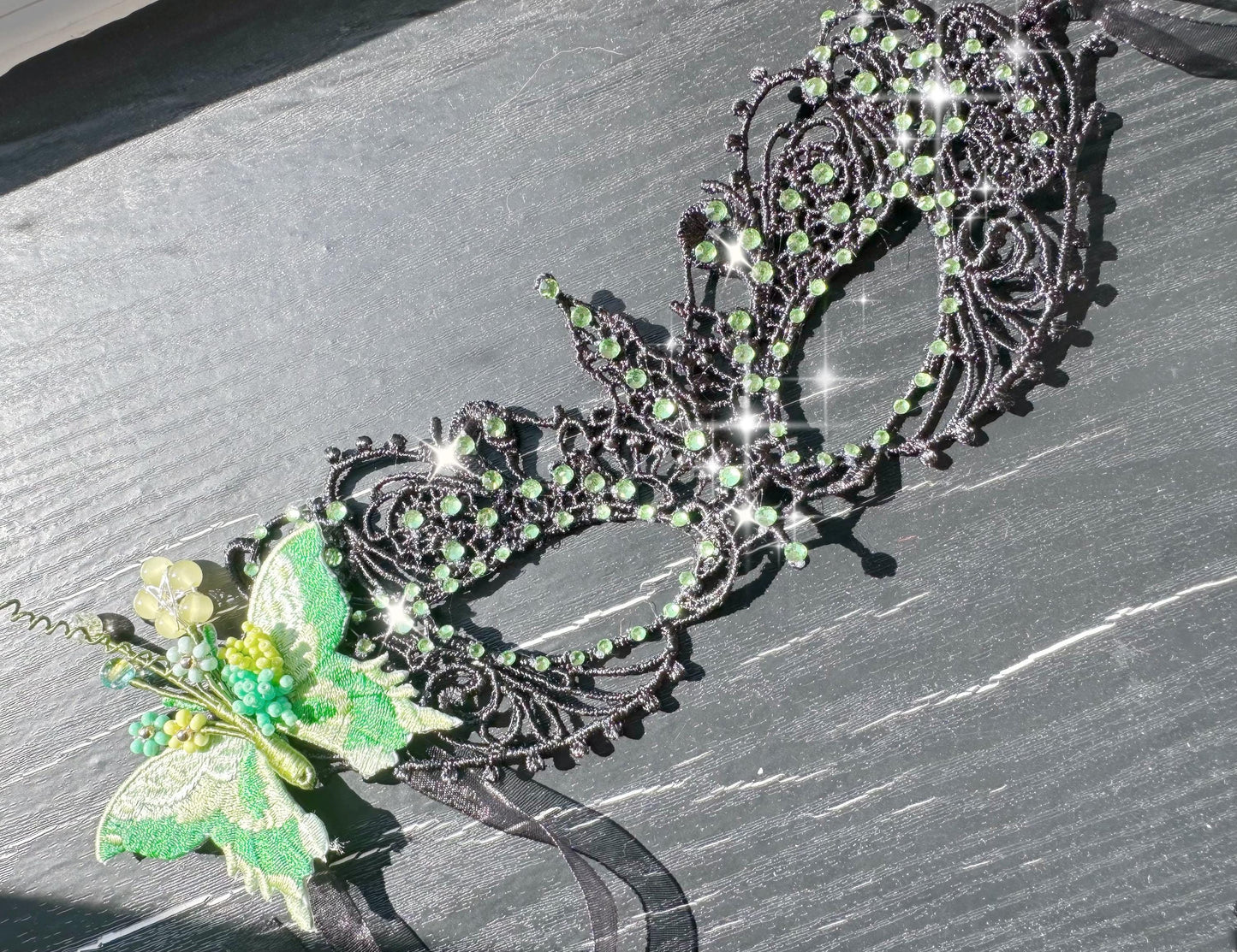 Handmade black lace masquerade mask with green color embroidered butterfly, green color rhinestones, and floral bead embellishments