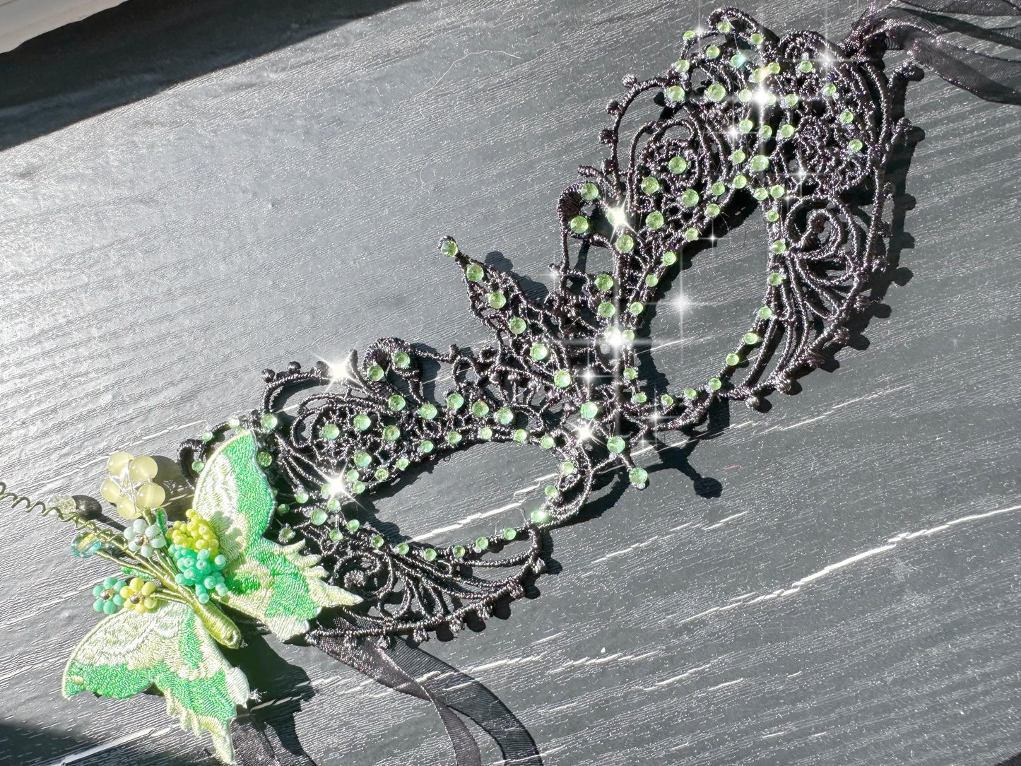 Handmade black lace masquerade mask with green color embroidered butterfly, green color rhinestones, and floral bead embellishments