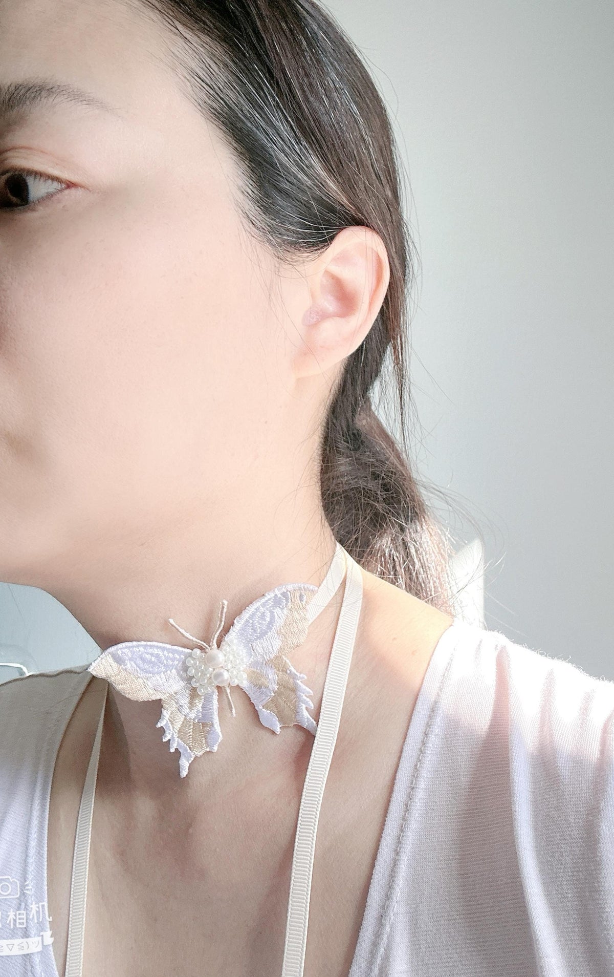 Handmade Choker featuring delicate hand-stitched embroidery of a Ivory color butterfly, adorned with freshwater pearls and glass seed beads