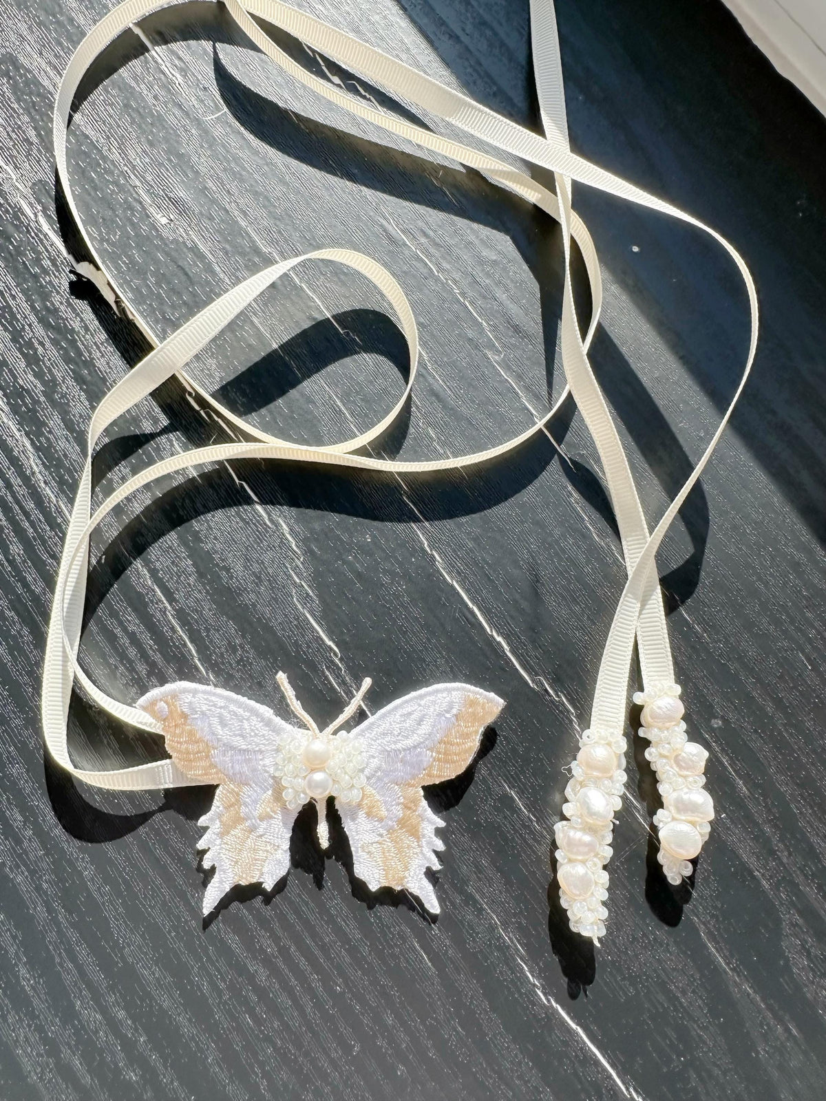Handmade Choker featuring delicate hand-stitched embroidery of a Ivory color butterfly, adorned with freshwater pearls and glass seed beads